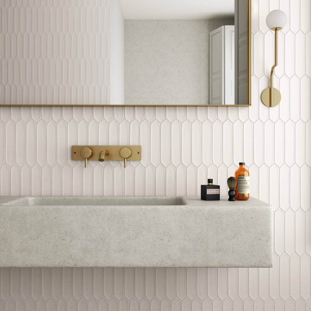 This bright modern bathroom features white picket tile and a floating sink. 