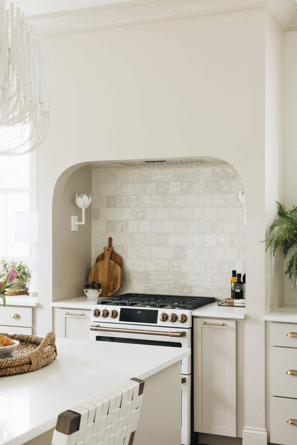 Bright kitchen with white square handmade-look tiled backsplash.