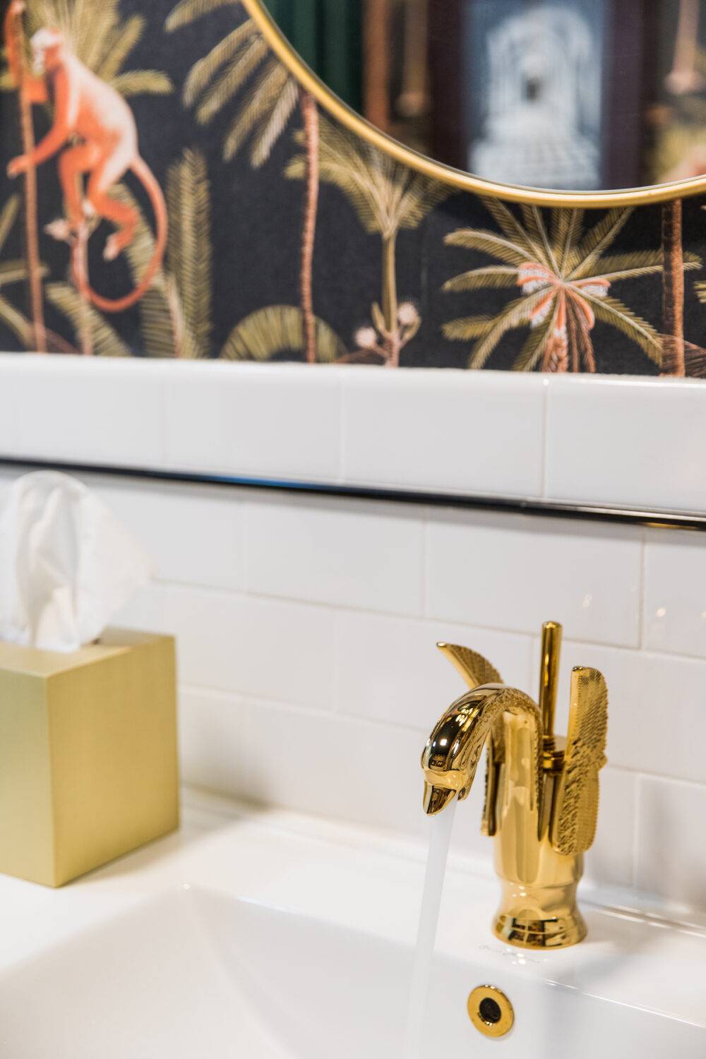 This funky bathroom features a white subway tile backsplash with a black pencil trim. 